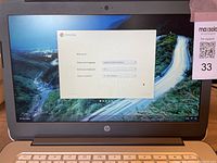 Front view of HP Chromebook 14 with screen on showing Chrome OS welcome page