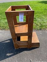 Side view of wooden learning tower showing sturdy frame and steps.