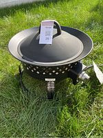 Top view of the steel fire bowl with lid and handle, showing overall condition and design.
