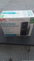 Box of APC battery backup system showing front with brand, product name, and key features.