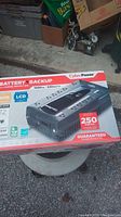 Photo of the boxed CyberPower Battery Backup UPS showing front of the packaging with power specifications and features.