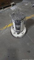 White Kerosun kerosene heater with metal protective cage and base from full top view showing heater