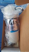 NSA water treatment unit sealed in plastic inside original box with visible NSA label and outlet fitting.