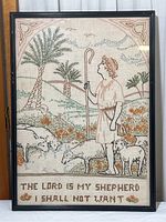 Full view of the framed cross stitch artwork showing the shepherd with sheep, trees, and text.