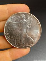 Obverse side of the 1993 American Silver Eagle coin showing Lady Liberty walking with detailed inscriptions and date.