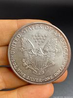 Reverse side of the 2004 American Silver Eagle coin showing heraldic eagle and silver weight/dollar markings.