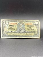 Front side of the $20 Bank of Canada bill showing King George VI portrait and serial number E3402771.