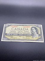 Front side of the Canadian $20 bill displaying the portrait of Queen Elizabeth II, serial number, and bilingual text.