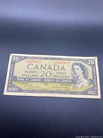 Front side of the Canadian $20 bill showing Queen Elizabeth II portrait, serial number, and denomination details.