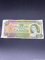 Front side of Canadian $20 bill showing Queen Elizabeth II and serial number EG5016308.
