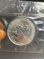 Obverse of the 2007 Canadian Silver Maple Leaf coin showing maple leaf design, 1 oz fine silver markings, and Canada inscriptions.