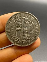Front side of the 1934 half crown coin showing the crowned shield with lions and inscriptions around.
