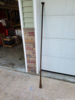 Full view of 6-foot digging bar leaning against a wall, showing overall length and shape.