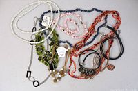 Overhead photo showing all jewelry laid out, revealing necklaces and bracelets in various styles, colors, and materials.