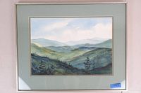 Framed original watercolor artwork by Josephine Mayo showing mountainous landscape with varying shades of green and blue.