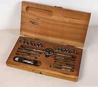 Wooden case open showing the entire vintage tap and die set with tools arranged inside.