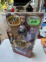 Front view of the Bratz Wild Wild West Dana doll in original packaging with accessories visible, including hat and purse.