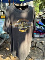 Front view of black Doobie Brothers 1989 tour T-shirt showing logo design.