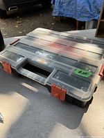 Closed view of HDX tool box organizer showing clear lid with orange latches and black handle.