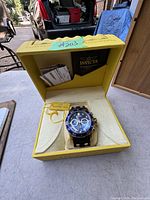 Invicta Pro Diver watch in yellow Invicta box with papers inside the lid.