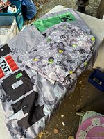 Photo showing the Minecraft themed double fitted sheet spread out with two matching pillow cases placed on top.