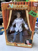 Front view of the N SYNC Lance Bass marionette in original box showing packaging, branding, and the figure inside.