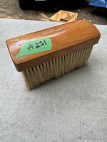 Top and side view of the wooden horse hair brush showing the Ralph Lauren brand name and natural bristles.