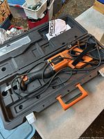 Ridgid Sawzall reciprocating saw in its black and orange carrying case with instruction manual visible.