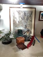 Frontal photo showing the framed botanical print with cattails, ceramic vase, Hakata figurine, wicker basket, brass bell, bamboo coasters, and decorative wooden items grouped together.