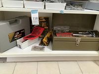 Overview of tools including the metal toolbox, red socket set, Parker electric stapler/nailer in packaging, gray Tornado Tools case, and assorted bits and small tools.