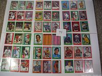 Photo showing a partial collection of O-Pee-Chee 1973-74 NHL hockey cards in various colorful borders, featuring multiple players and some all-star cards.