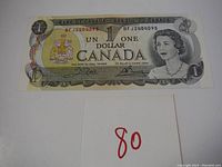 Front of the 1973 Canadian one dollar bill showing Queen Elizabeth II and coat of arms.