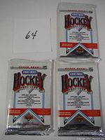 Three sealed 1991-1992 Upper Deck LNH-NHL hockey trading card packs arranged together, each with distinct pack graphics and text.