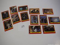 Overview of 13 trading cards from the Alien movie, laid out on white surface showing various characters and scenes.