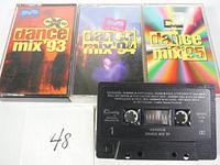 Four Dance Mix cassette tapes with cases and one tape without case, front views of the covers and tape shown.