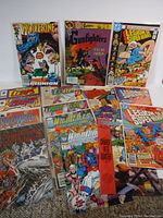 Lot of vintage comics displayed showing front covers upright including Wolverine, Gunfighters, Legion of Super-Heroes and others.