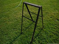 Photo showing the sandwich sign frame standing open fully on grass, displaying its size and folding design.