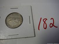 Silver coin featuring a cougar design dated 1867-1967, mounted in a white cardboard holder with clear plastic window.