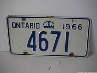 Front side of a 1966 Ontario license plate with number 4671, showing white background and blue embossed text and crown emblem.