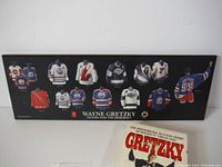 Plaque showing miniature jerseys of Wayne Gretzky's career.