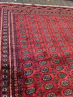 Center field showing repeating oval gul motifs in red, black, green, and cream.