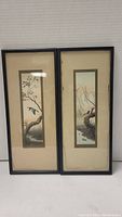 Pair of vertical framed watercolour bird paintings side by side, one mat with water damage