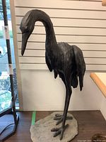 Full front view of entire bird statue and base