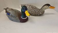 Pair of Heritage Decoy ducks, male and hen, displayed side by side on white background.