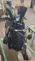 Front view showing Ping stand bag on two-wheel pushcart and second Callaway bag behind