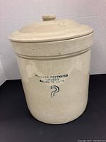 Full view of the 2 gallon crock showing the Medalta Potteries Limited stamp and question mark symbol on the side.