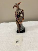 Royal Doulton The Jester porcelain figurine standing on a white towel surface with lot card number 26 visible.