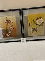 Two framed silk batik watercolours displayed side by side, showing traditional Chinese floral and bird themes with bamboo style frames.