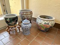Frontal shot showing all four porcelain pots and two wooden stands