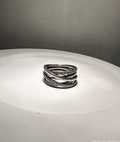 Photo of Pandora sterling silver ring size 9 with multiple bands, some polished silver and some rows with cubic zirconia stones.